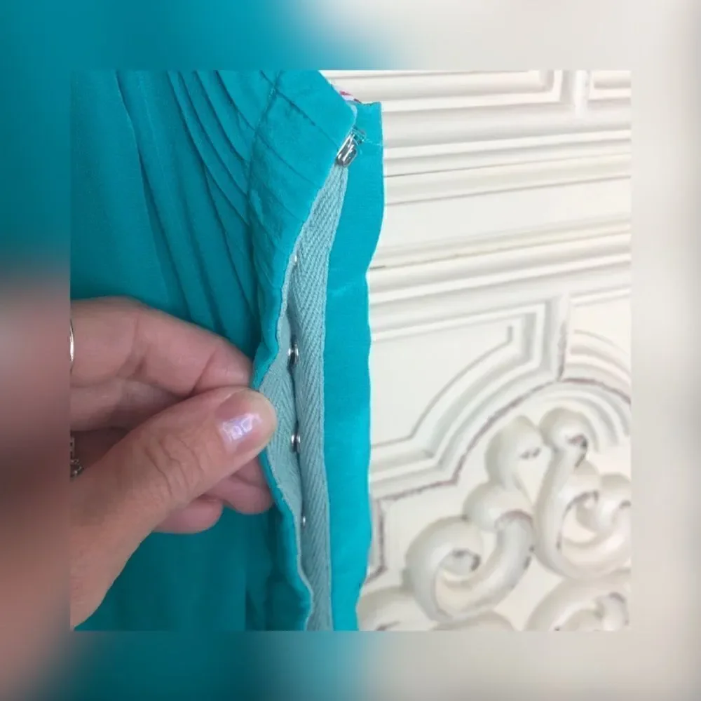 Turquoise wink romper with ruffle details size small